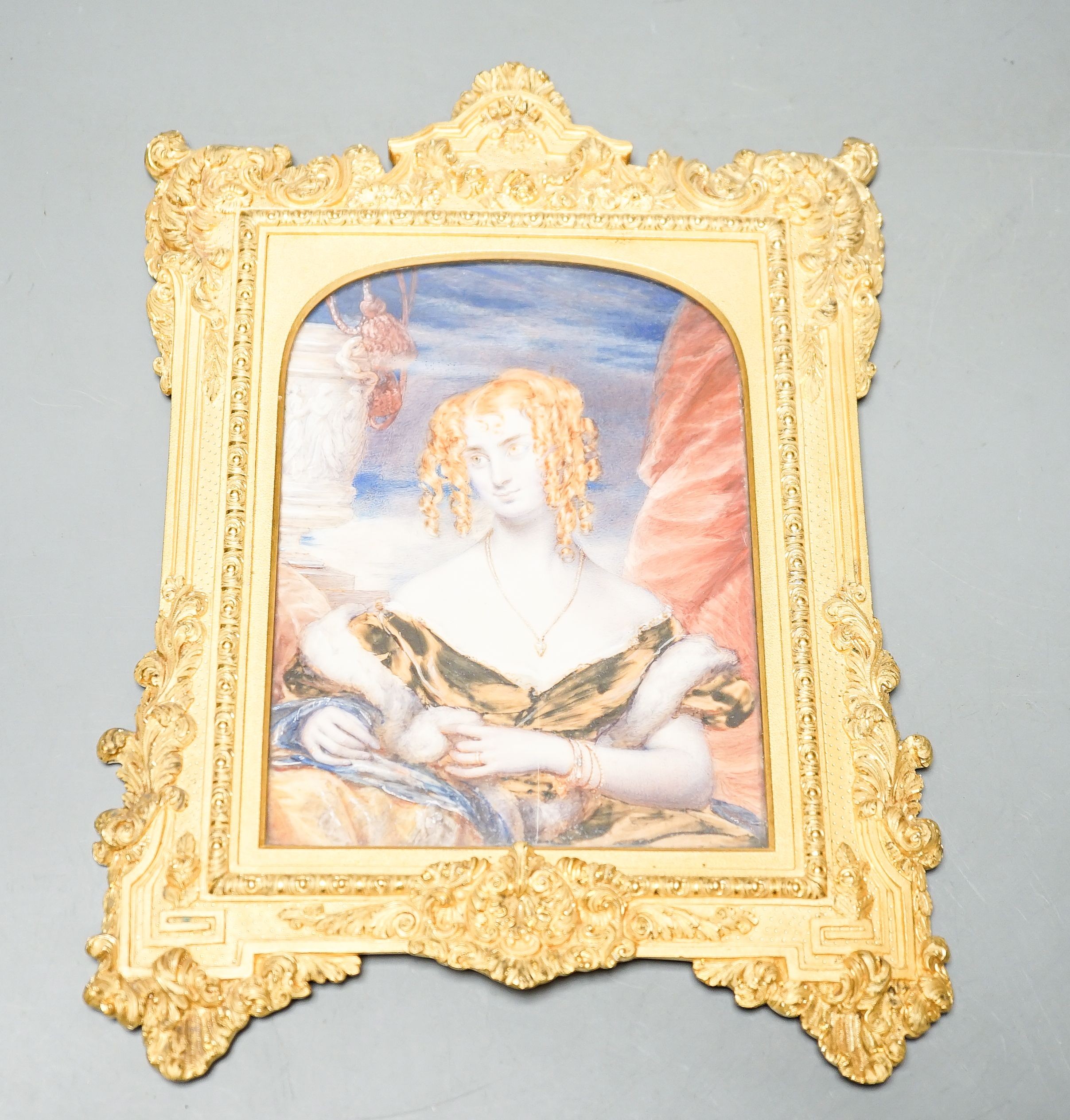 19th century ormolu framed portrait miniature on ivory of a young lady with auburn hair. Length of frame - 23cm